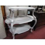 A Continental Painted Three Tier Table, with shaped shelves on cabriole supports, 98.5cm wide.