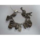 A Curb Link Charm bracelet, suspending numerous novelty charm pendants, including hand bell,