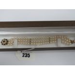 A Three Row Uniform Pearl Bead Bracelet, to 9ct gold cluster clasp.