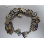 A Curb Link Charm Bracelet, suspending numerous souvenir enamel shield pendants etc.