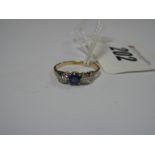 A Sapphire and Diamond Three Stone Ring, alternately set, claw set throughout, between textured