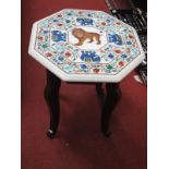 An Octaganal Shaped Marble Specimen Table, decorated with elephants and a lion, on a stand.