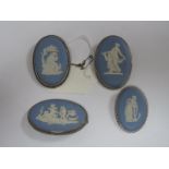 Four Wedgwood Blue and White Jasperware Oval Panel Brooches, collet set. (4)