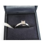 A Modern Platinum Princess Cut Single Stone Diamond Ring, four claw set, between plain shoulders. *