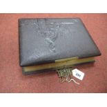 A XIX Century Tooled Leather Bound Photo Album, with brass clasp, musical facility and period