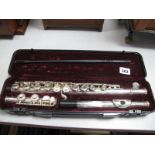 An American Three Piece Flute, stamped USA, in plush lined case.
