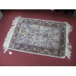 A Persian Style Silk Rug, with floral decoration, tassel ends.