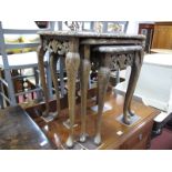 A XX Century Walnut Nest of Tables, with glass tops, on cabriole legs.
