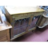 An Oak Display Cabinet, with twin lead glazed doors on turned and block supports, 96.5cm wide.