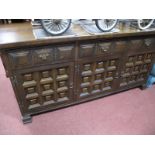 An Oak Sideboard, with three top drawers, over panelled cupboard doors.