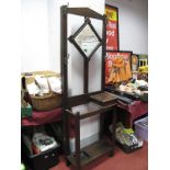 A XX Century Oak Hall stand, with a central mirror, glove drawer, under shelf with drip tray.