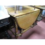 An Oak Drop Leaf Gate Leg Table, on turned and block supports.