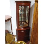 Yew Wood Double Corner Cupboard, with a glazed door, over a cupboard door, on bracket feet.