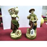 A Pair of Royal Dux Pottery Figures of Peasants, she carrying an urn, a sheep by her feet, he with a