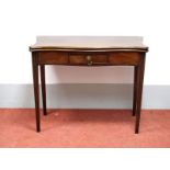 A George III Mahogany Serpentine Side Table, circa 1770, on reeded square tapered legs.