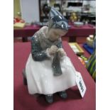 A Royal Copenhagen Porcelain Model of Amager Girl Knitting, designed by Lotte Benter, printed and