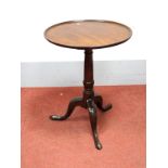 An XVIII Century Mahogany Pedestal Table, with circular dish top, turned pedestal on cabriole legs