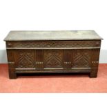 A Late XVII Century Joined Oak Blanket Box, with a carved frieze, the base with three carved panels,