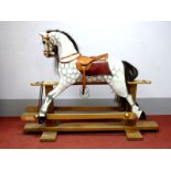 A XIX Century Style Painted Wooden Rocking Horse, in dapple grey with leather saddle, on trestle