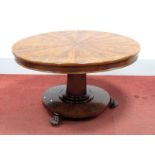 A XIX Century Mahogany Centre Table, with circular quarter veneered top, octagonal tapering