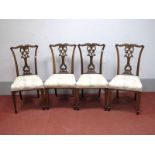 A Set of Four Early XX Century Rosewood Chairs, with pierced splat and upholstered seats on tapering