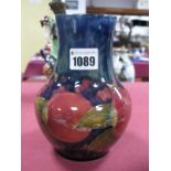 A Moorcroft Pottery Vase, of baluster form, painted in the 'Pomegranate' pattern against a dark blue