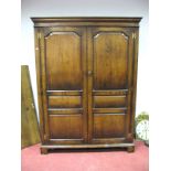 A Titchmarsh & Goodwin Oak Wardrobe, with stepped pediment, twin panelled doors, on bracket feet,