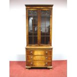 A Bevan Funnell Mahogany Bookcase, with dentil cornice and glazed astragal doors, the base with