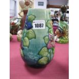 A Moorcroft Pottery Vase, of tapered form, painted in the 'Bougainvillaea' pattern against a