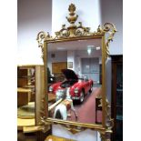 A Rectangular Wall Mirror, in the Regency style, with gilt wood frame having vase cresting and