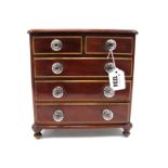 A XIX Century Mahogany Miniature Chest of Drawers, with two small and four long drawers, glass