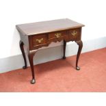 An XVIII Century Mahogany Lowboy, the top with a moulded edge, three drawers, shaped apron, on