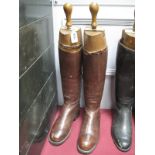 A Pair of Brown Leather Riding Boots, with wooden trees by Faulkner & Son, London, Camberley and