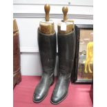 A Pair of Black Leather Riding Boots, with wooden trees by A.E. Millner, Peal & Co, London.