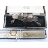 A Victorian Coin Bracelet, a three stone stick pin and a plain wedding band stamped "22ct". (3)