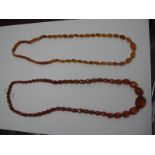 A Single Strand Graduated Faceted Amber Coloured Bead Necklace; together with another, similar. (2)