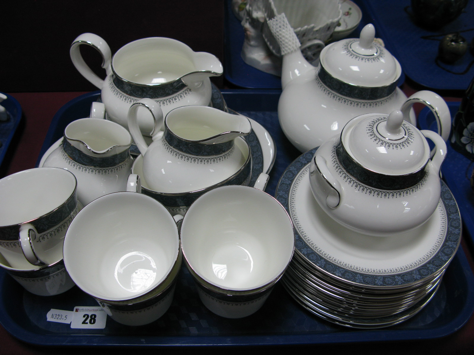 A Royal Doulton 'Sherbrooke' Tea Service, tea pot, cream jug, plates, cups and saucers, cake plate:-