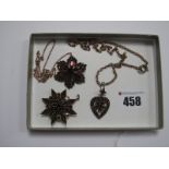 A Flowerhead Pendant, on integral chain, a garnet set pendant/brooch of star design, an openwork