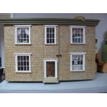 A XX Century Dolls House, two storey with sash windows, moulded cornice, with a large and full