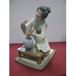 Lladro 'Orental Lady with a Vase of Flowers', height 19cm.