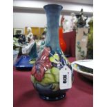 A Moorcroft Pottery Vase, of baluster form with elongated neck, painted in the 'Hibiscus' pattern on