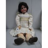 An Early XX Century Porcelain Headed Doll, by Simon Halbig of Germany, head stamped 1923/SP 5¾, with