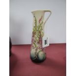 A Moorcroft Pottery Jug, painted in the 'Cornish Heath' pattern, designed by Vicky Lovatt, impressed