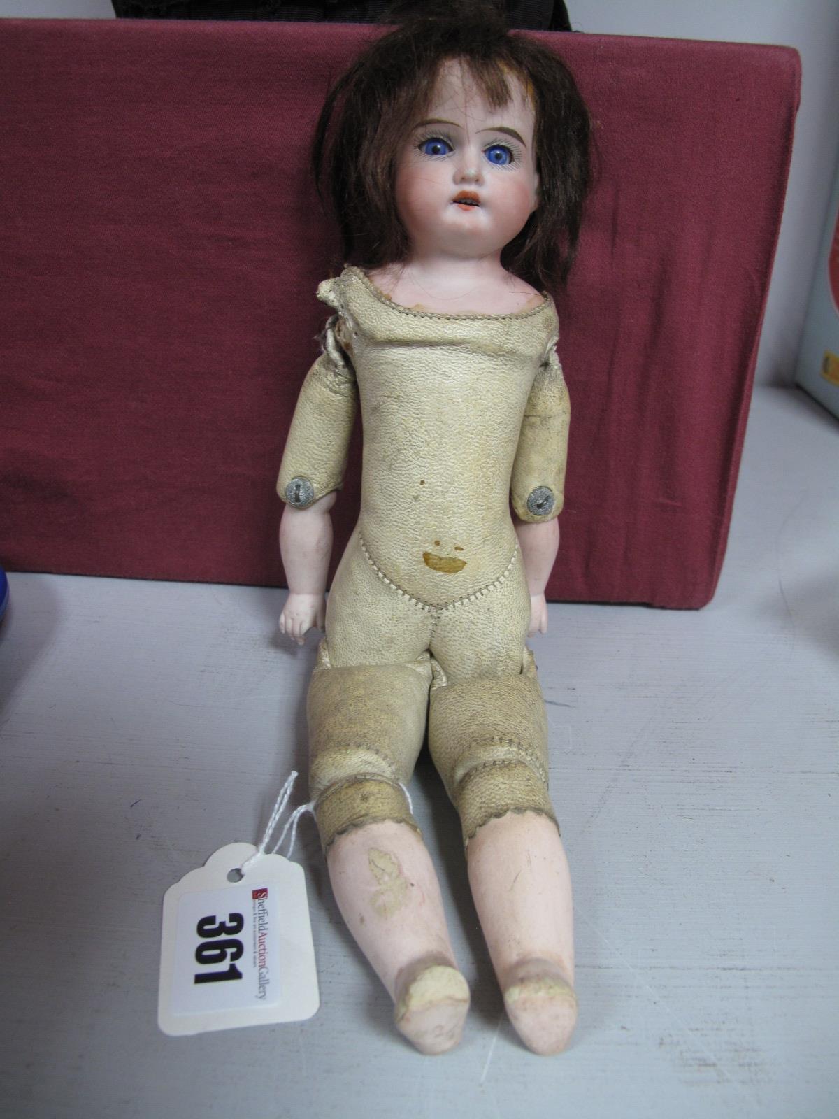 An Early XX Century Porcelain Headed Doll, with sleepy eyes and open mouth with teeth, leather