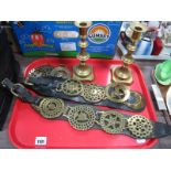 A Pair of XIX Century Brass Candlesticks, leather Martingale horse brass straps, with four brasses