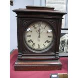 An American Late XIX Century Walnut Mantel Clock, with a glazed circular door, white dial Roman