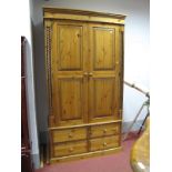 Pine Double Wardrobe, having twin doors to hanging compartment of two banks of two drawers with