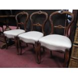 A Set of Three XIX Century Walnut Salon Chairs, the top and centre rails with quatrefoil decoration,