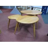 Ercol; A Nest of Three Light Elm Pebble Top Coffee Table, each on three spindle legs, the tallest