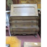 A XX Century Oak Dutch Style Bureau, with a fall front, three long drawers, on claw and ball feet.